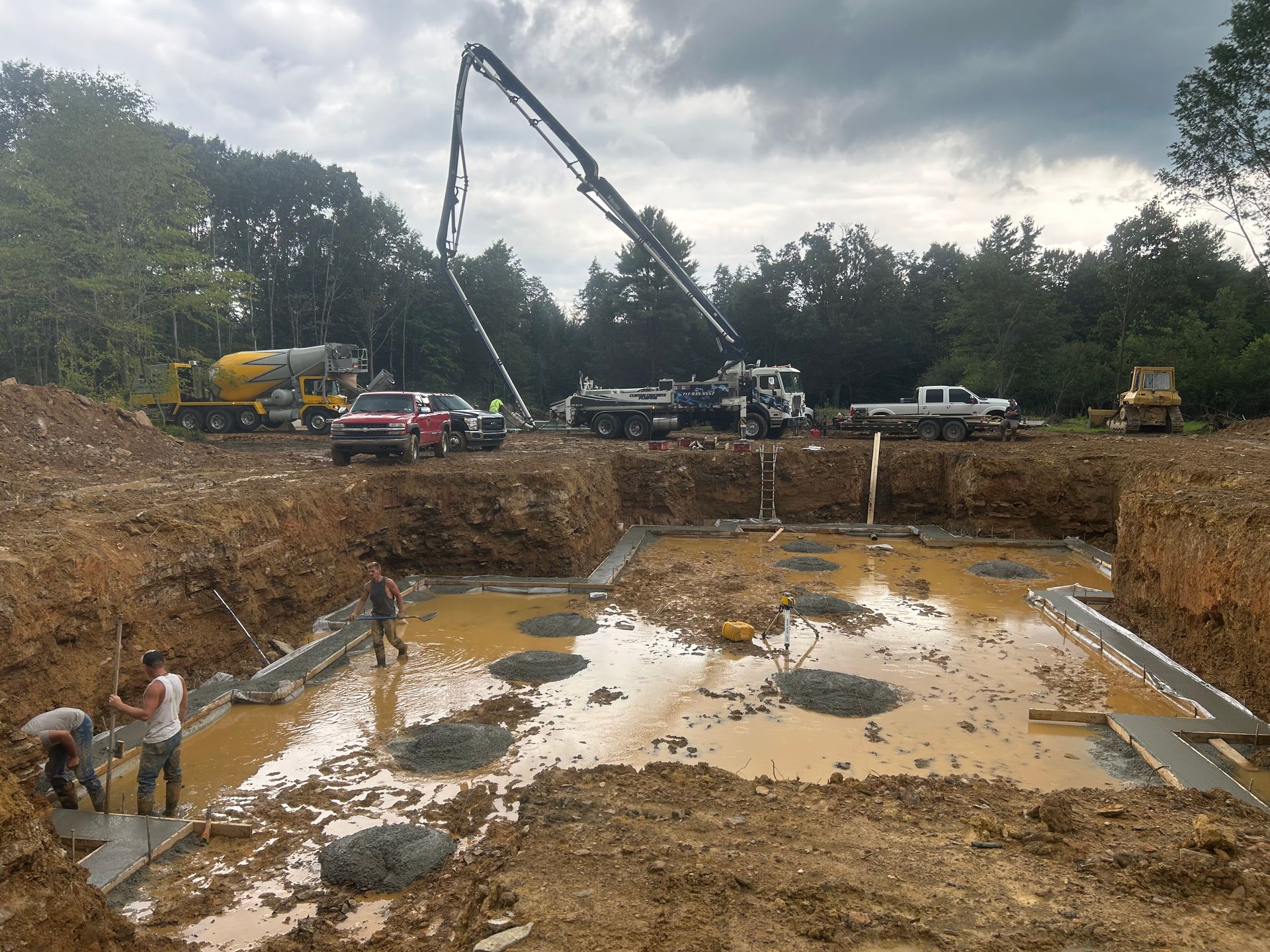 A construction site with a lot of dirt and trucks
