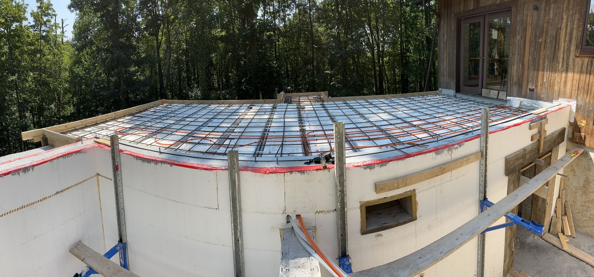 A large concrete slab is being built on top of a building.