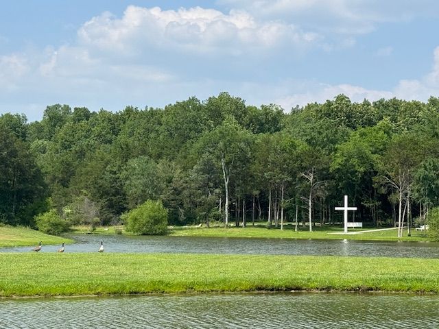 A lake with a cross in the middle of it