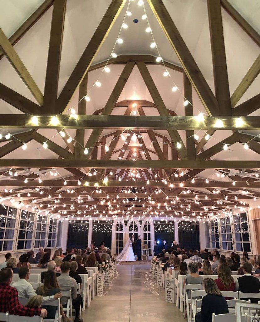 A bride and groom are getting married in front of a crowd of people