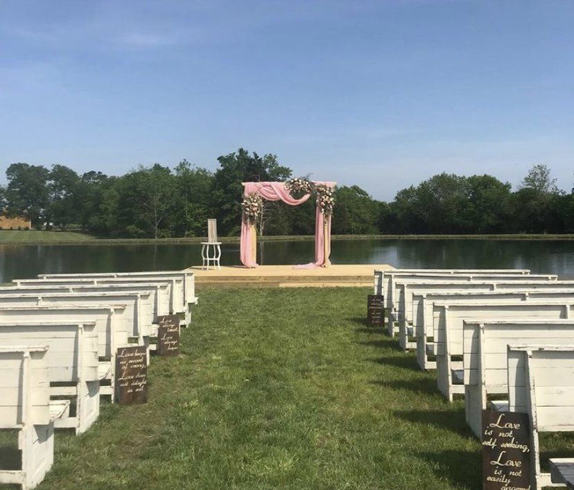 A wedding ceremony is taking place in front of a lake.