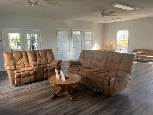 A living room with brown furniture and a table