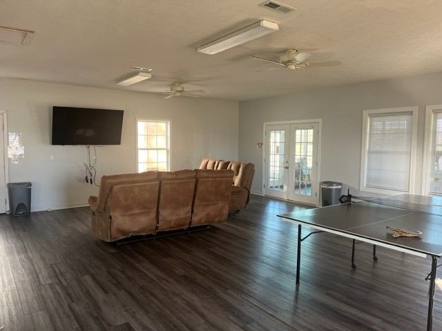 A living room with a couch , table and television.