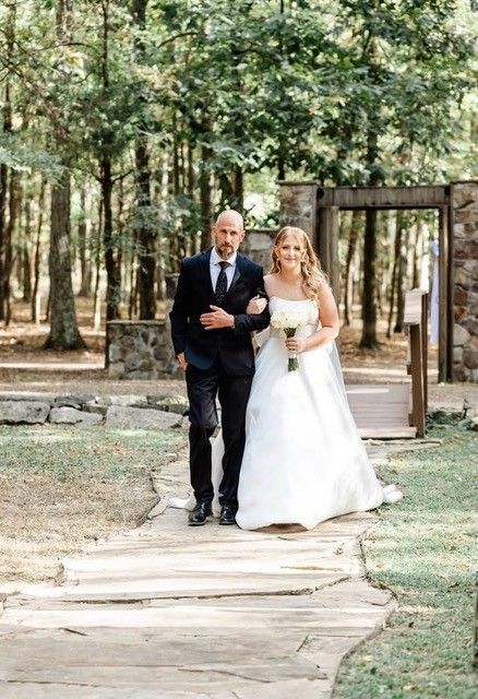 Bride and groom walking down a forest path after their wedding ceremony