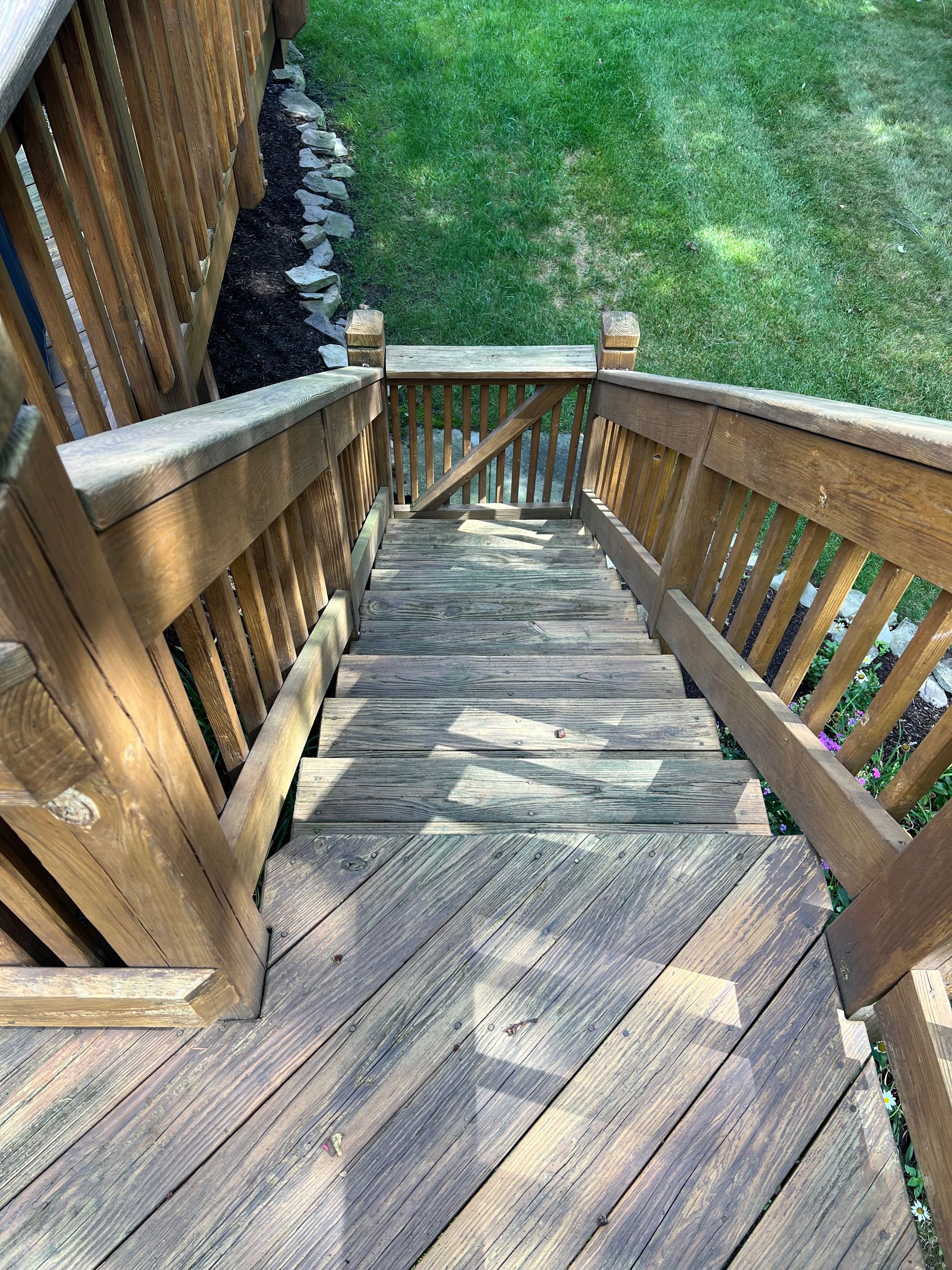 A wooden deck with stairs leading up to it.