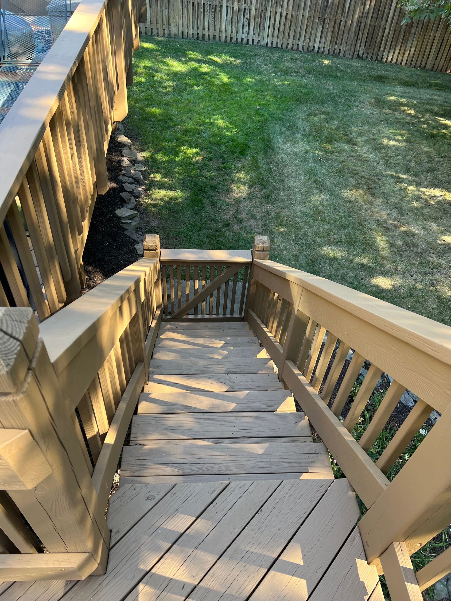 A wooden deck with stairs leading up to it