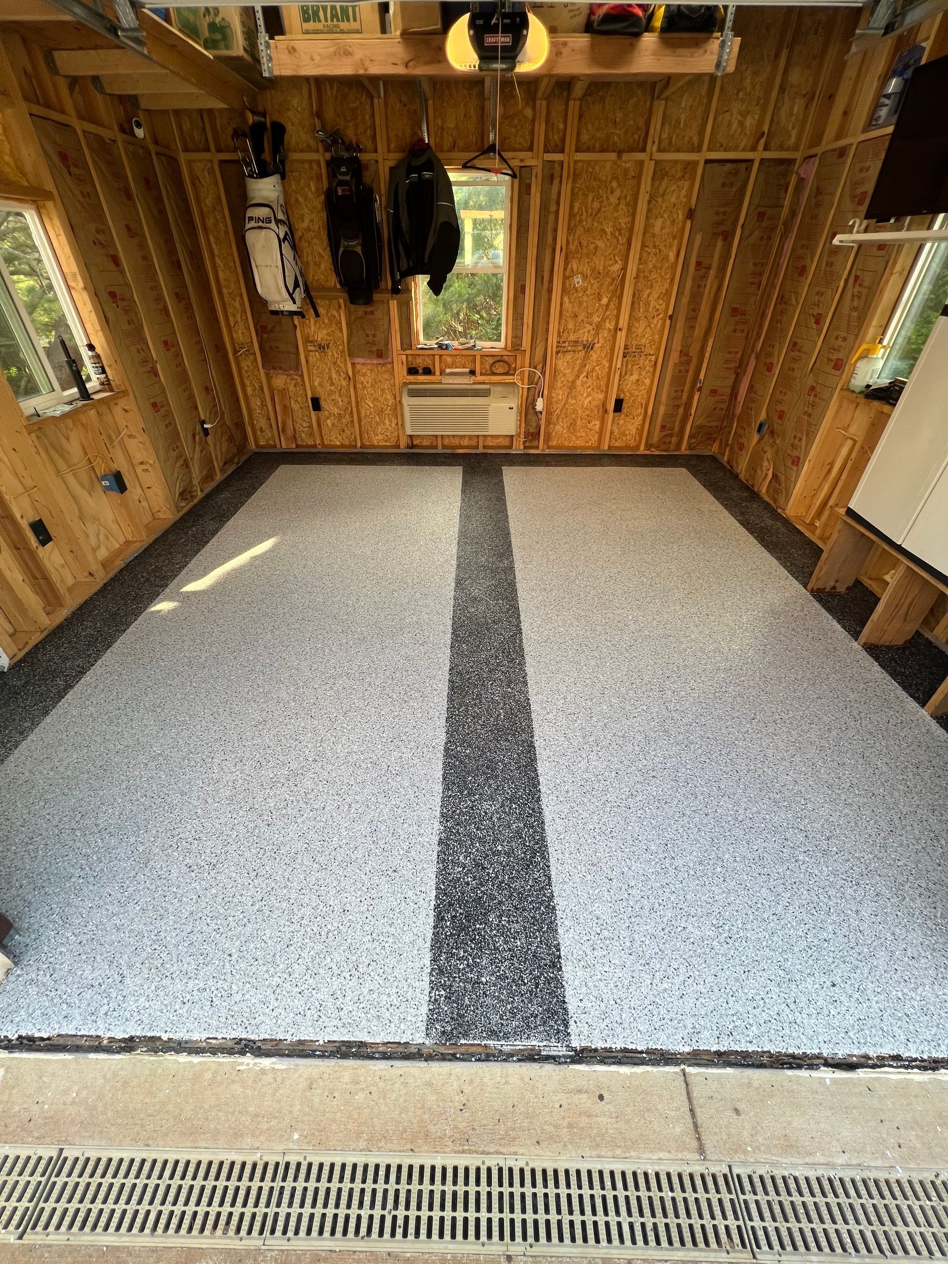 A garage with a gray and black striped floor.