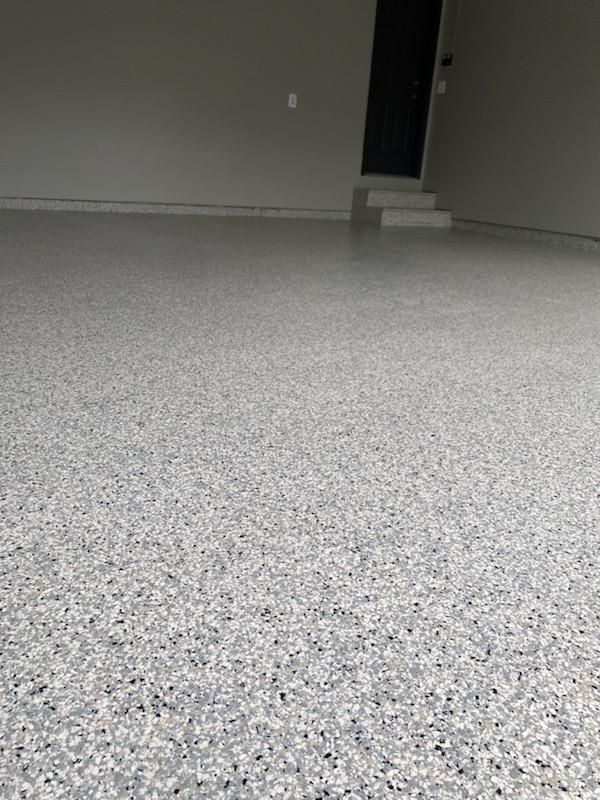 A vacant garage with a coating applied to the floor.
