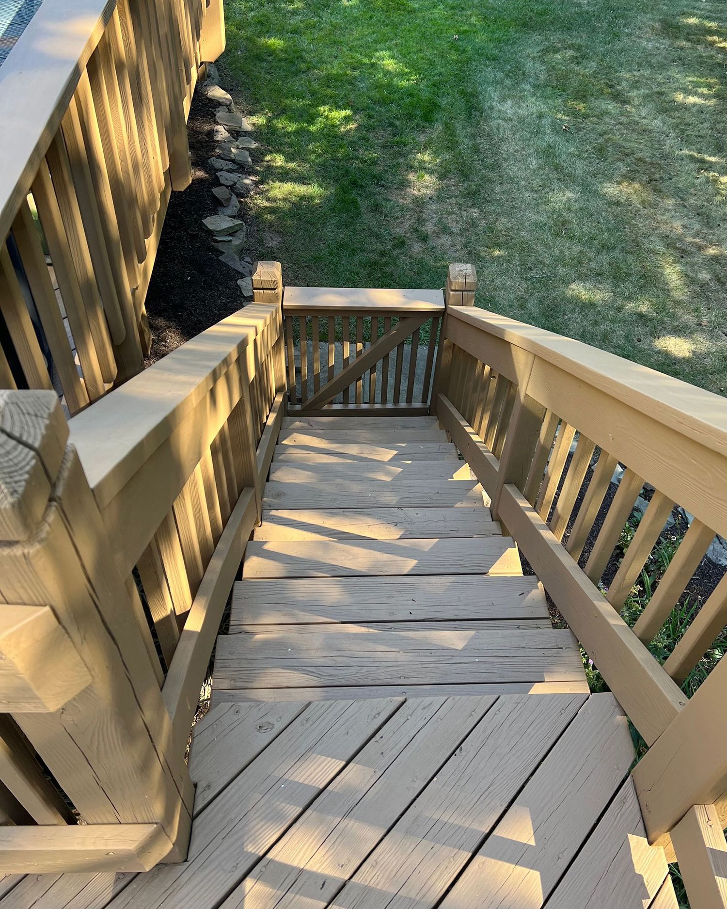 A wooden deck with stairs leading up to it.