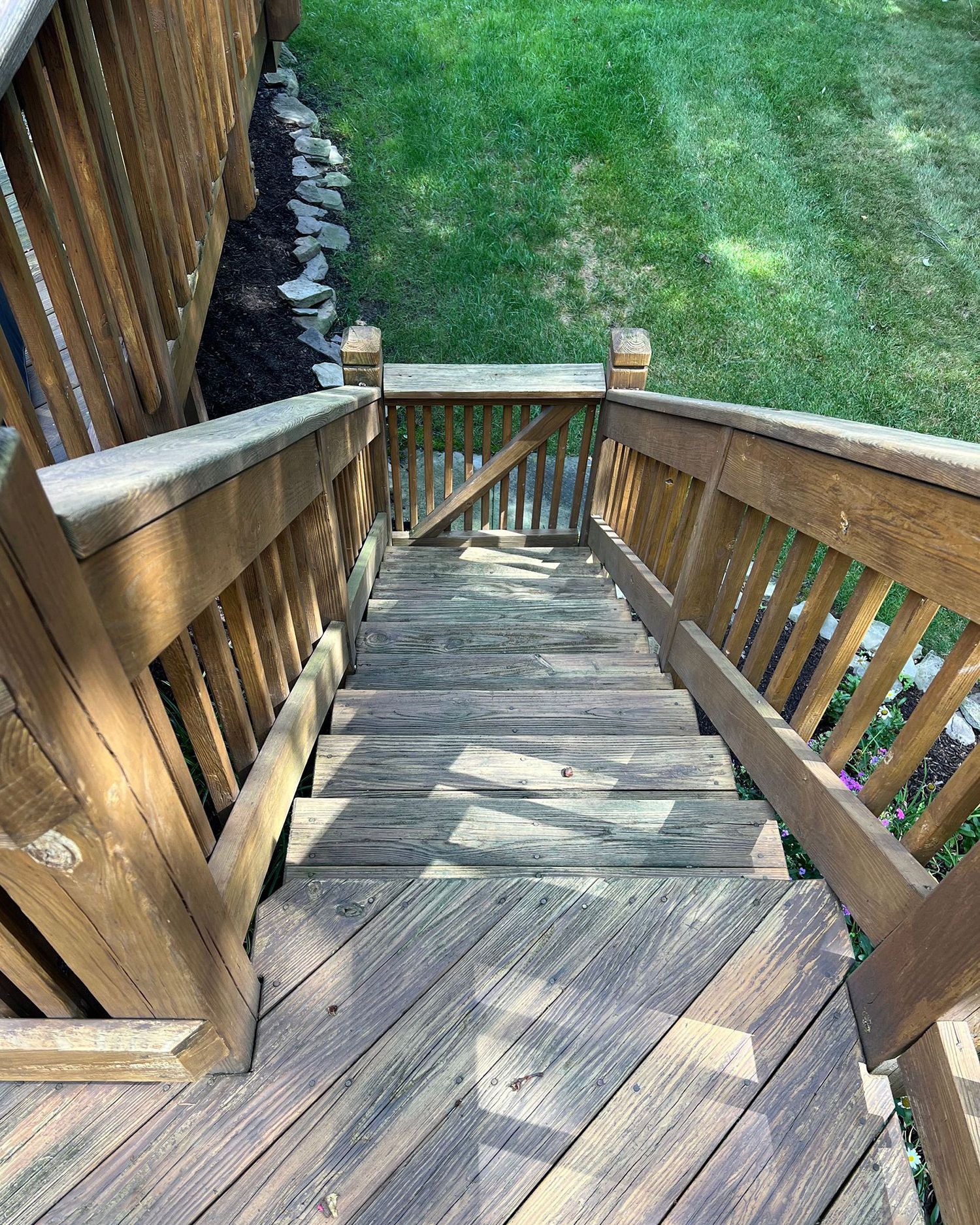 A wooden deck with stairs leading up to it.