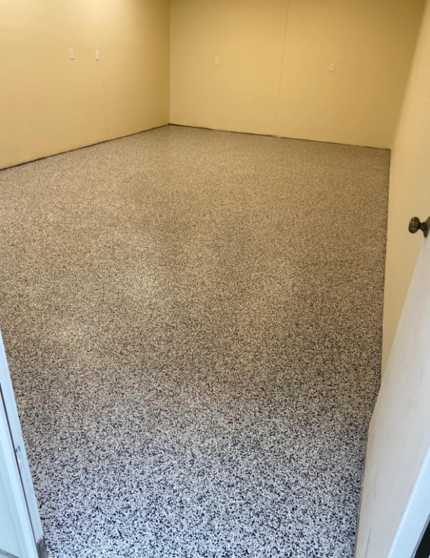 An empty room with a concrete floor after