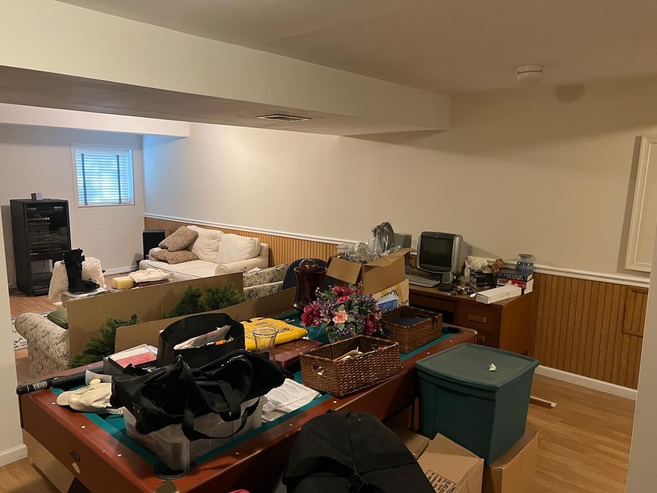 A living room filled with lots of boxes and a table.