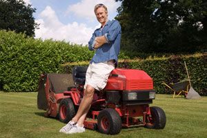 Man leaning on a lawn mower