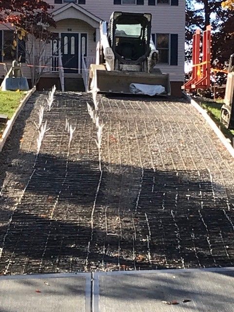 Concrete truck pouring a new driveway at a house under construction