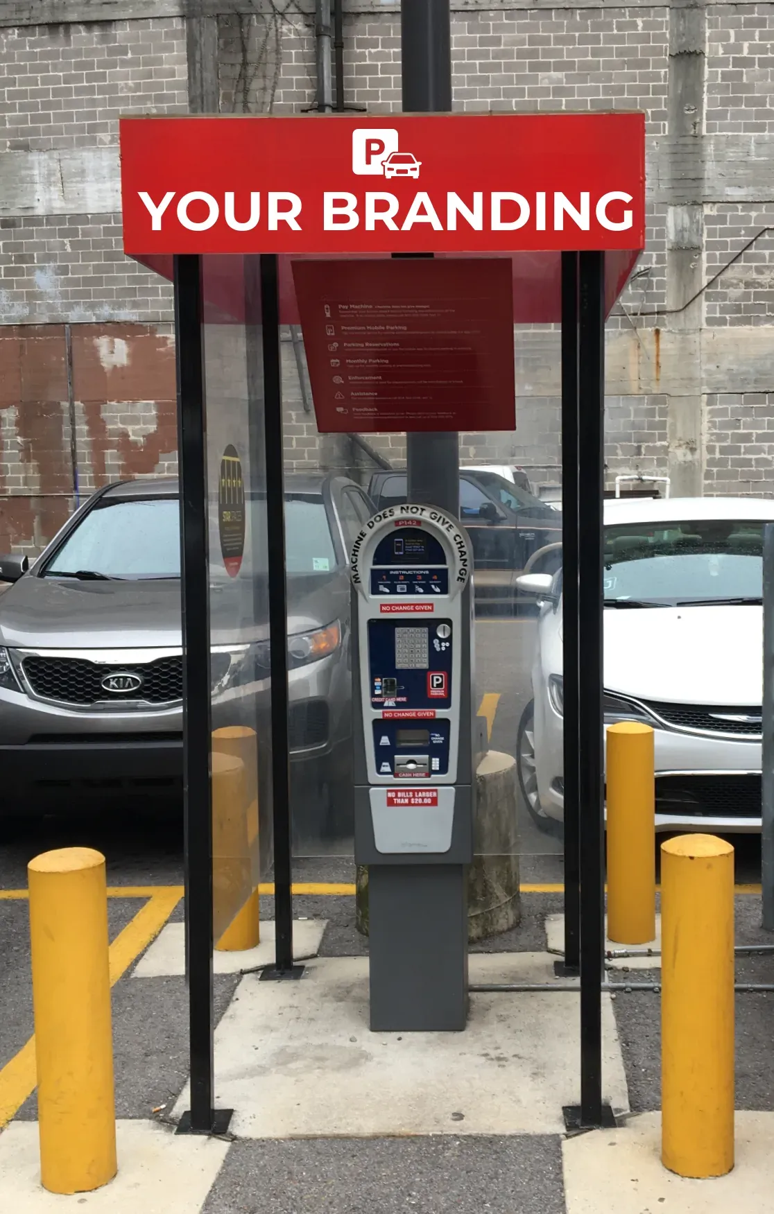 Parking meter kiosk under a red “YOUR BRANDING” sign, flanked by yellow bollards, with cars behind.