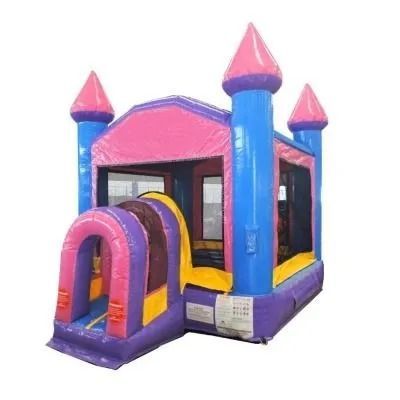 Pink and blue inflatable bounce house with castle turrets and entrance tunnel