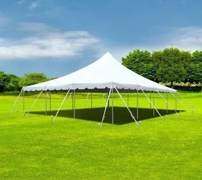 White event tent on a green lawn under a blue sky