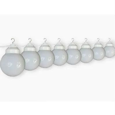 Row of hanging frosted white Christmas ornaments on a white background