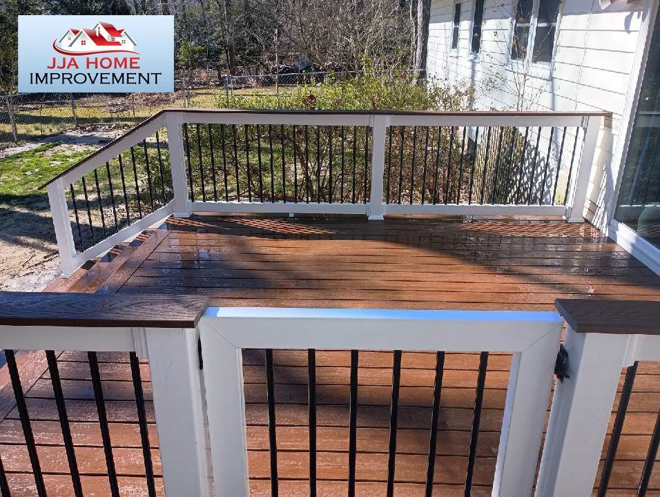 A wooden deck with a white railing