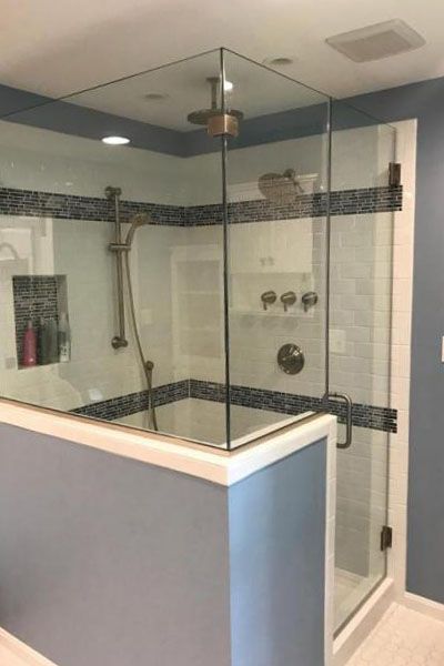 A bathroom with a walk in shower and a bathtub.