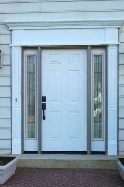 A white door with two windows on a house