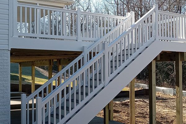 A white deck with stairs leading up to it