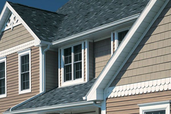 A house with a gray roof and brown siding