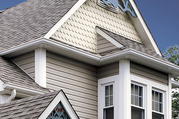 A house with a gray roof and white siding