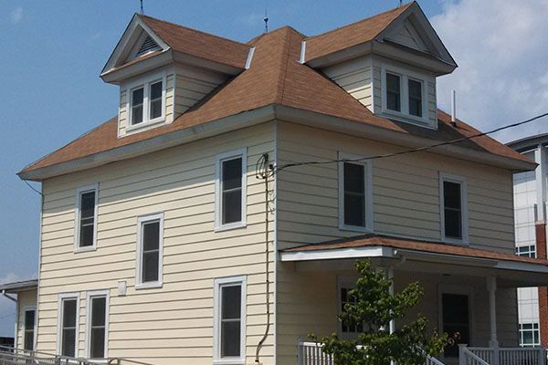 A large white house with a brown roof