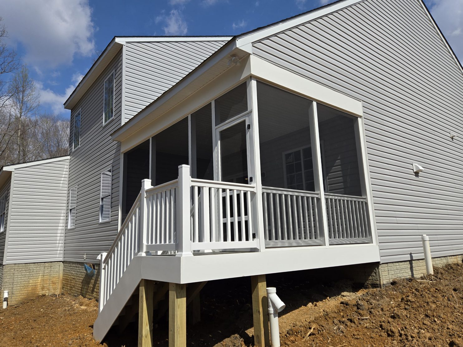 A screened in porch on the side of a house