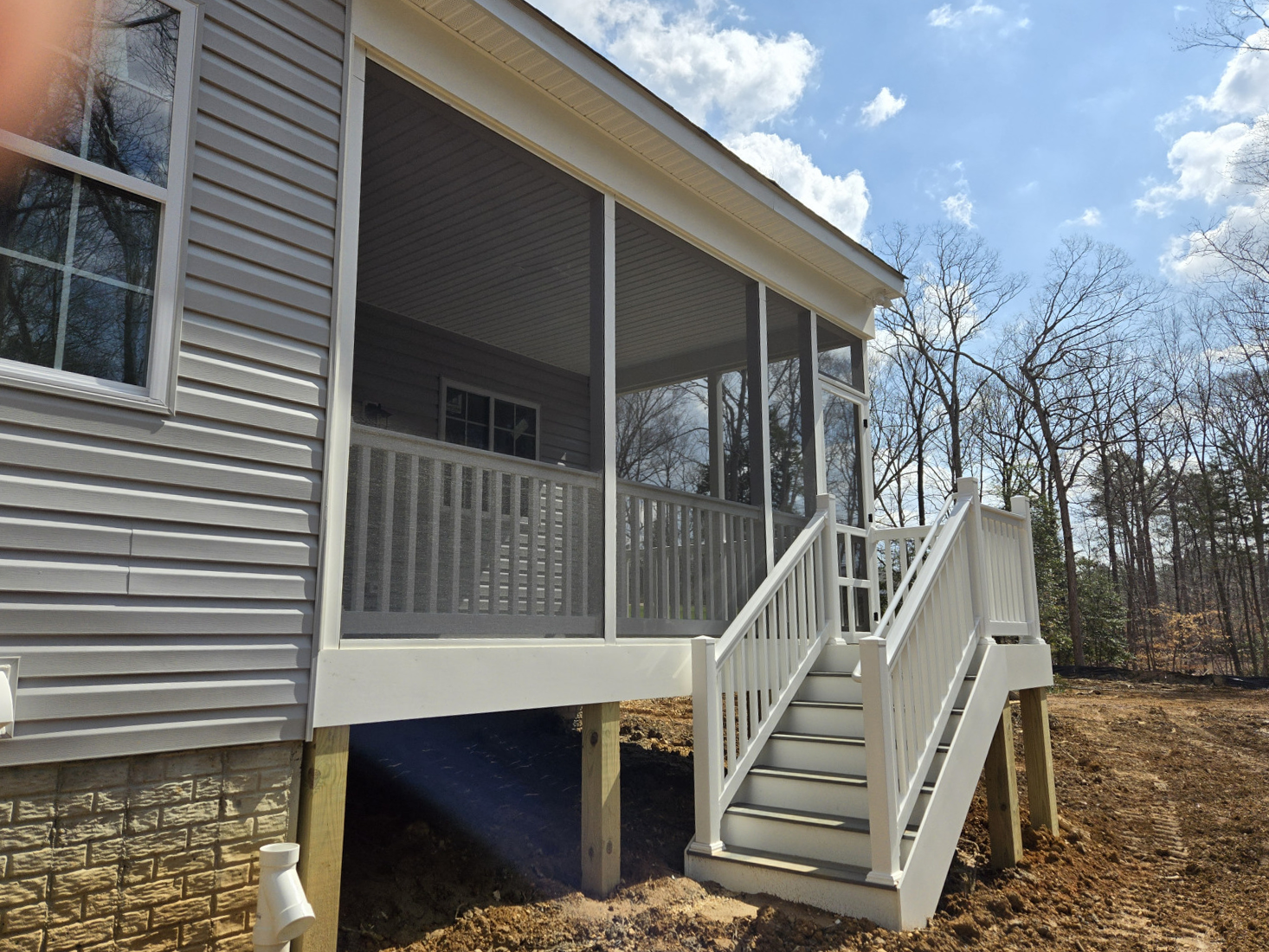 A house with a screened in porch and stairs