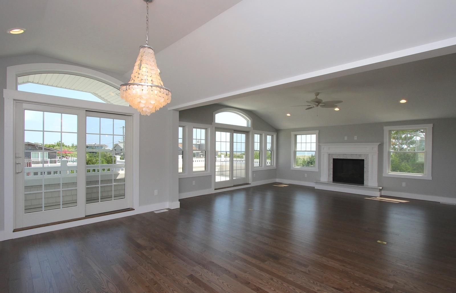 an empty living room with hardwood floors and a fireplace