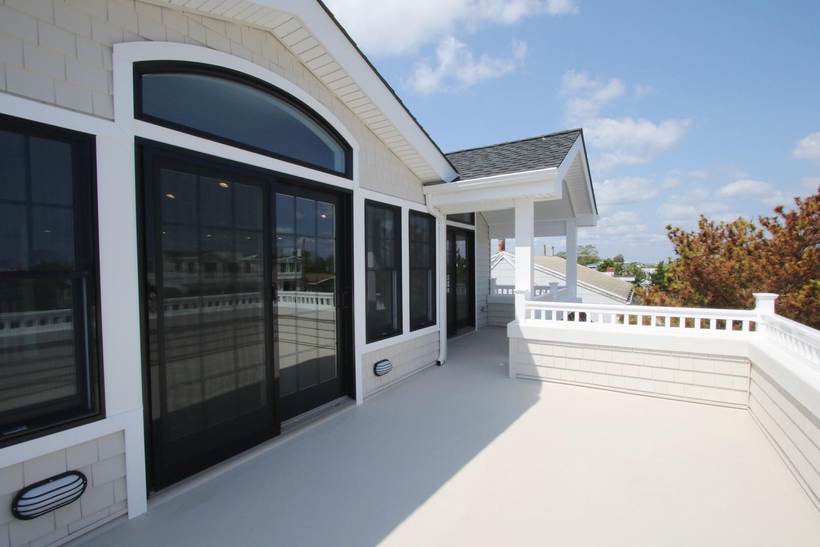a house with a balcony and sliding glass doors