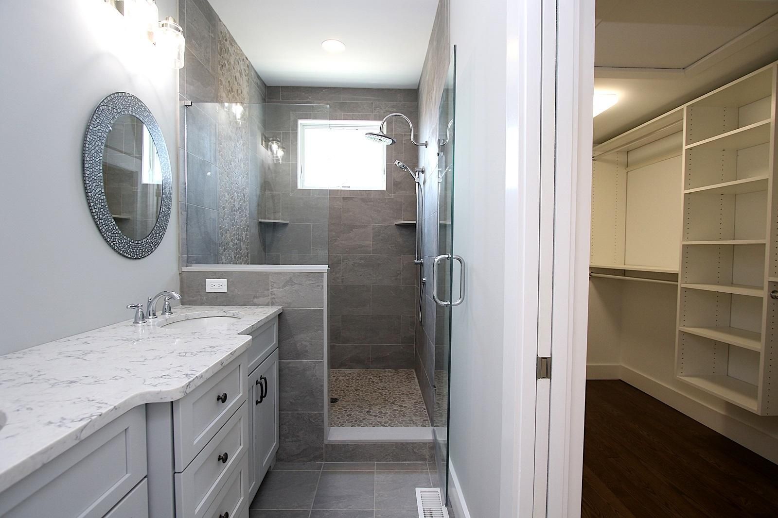 a bathroom with two sinks and a walk in shower