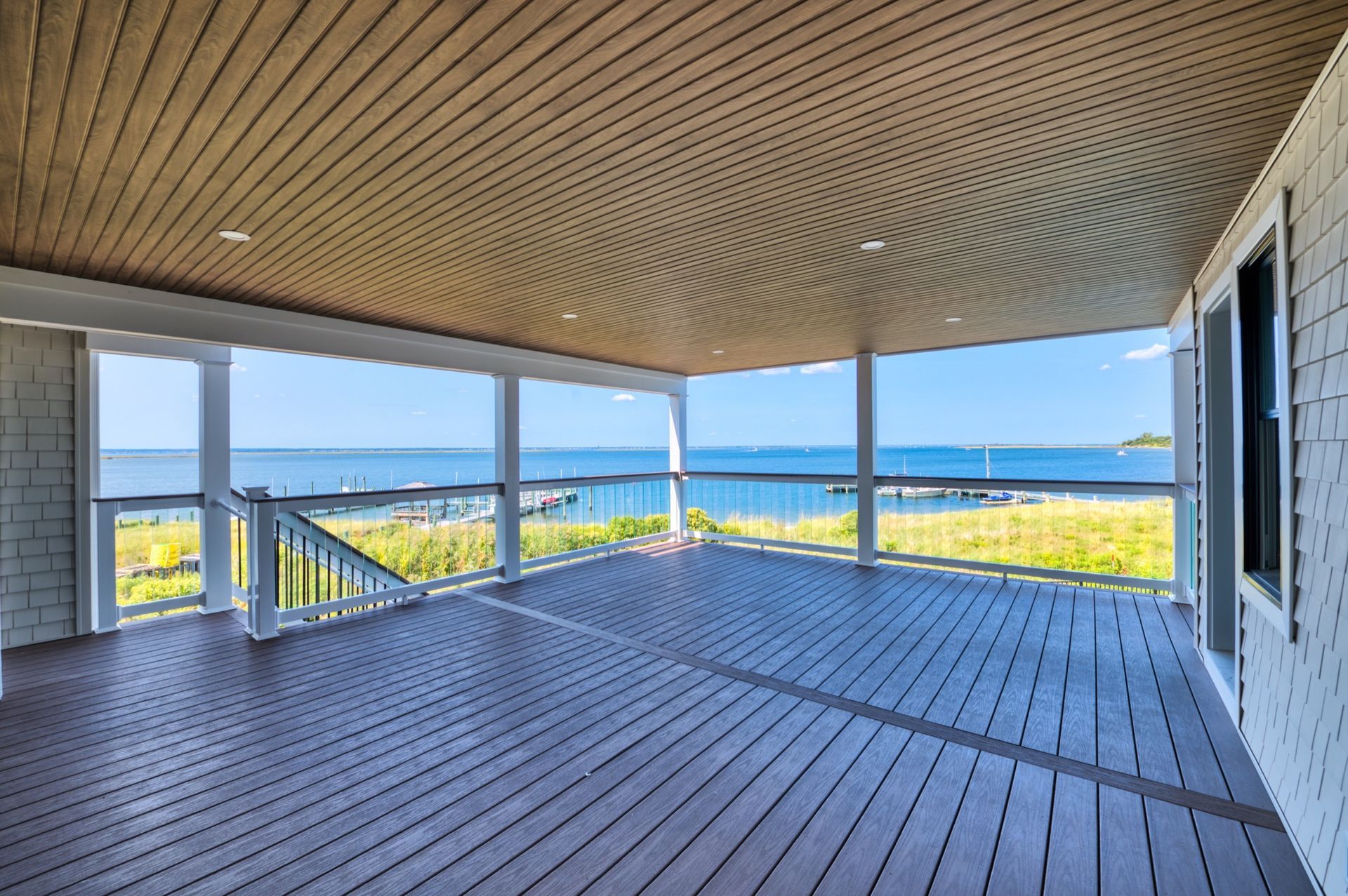 there is a large deck with a view of the ocean .