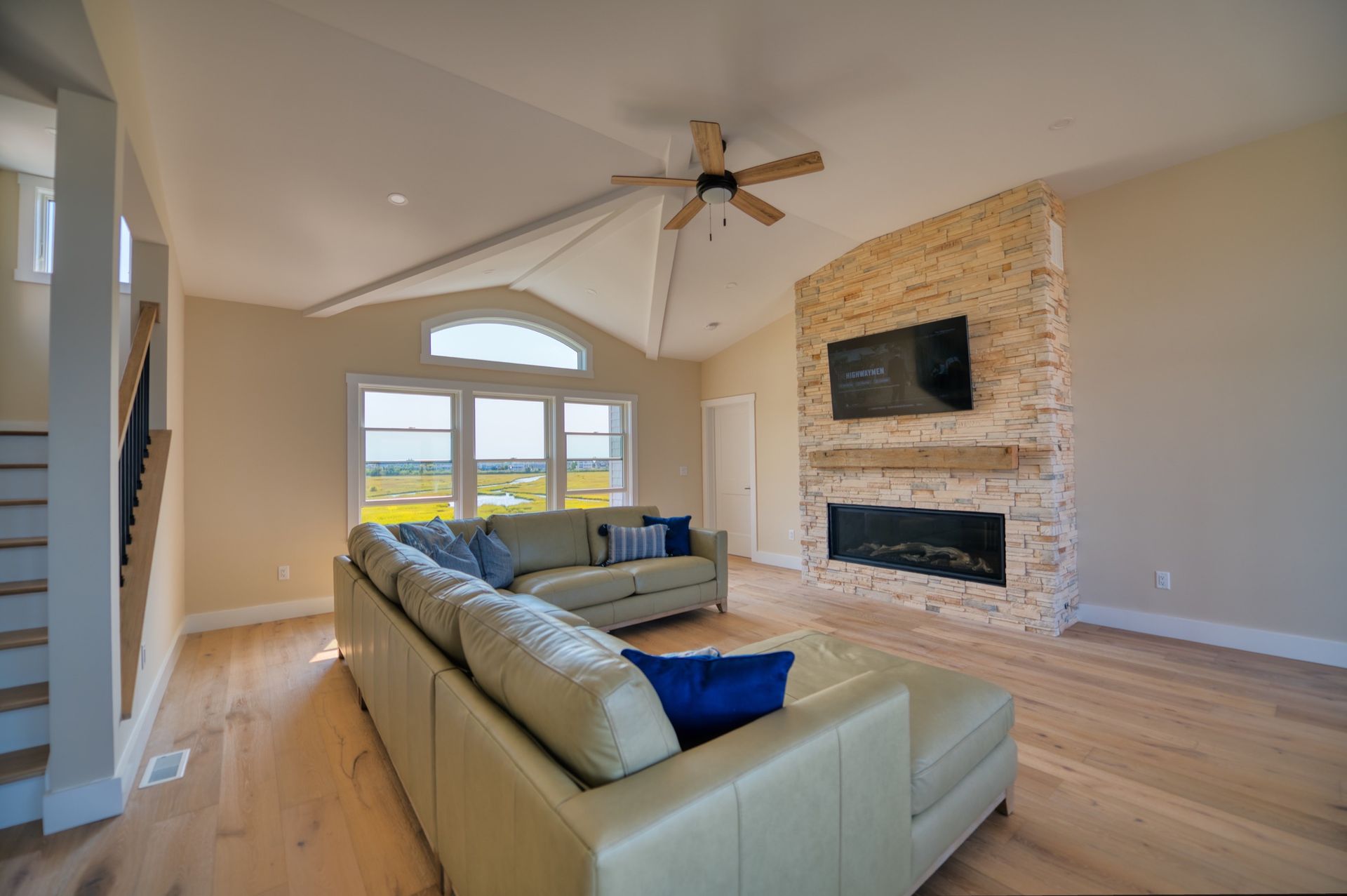 a living room with a couch , fireplace and television .