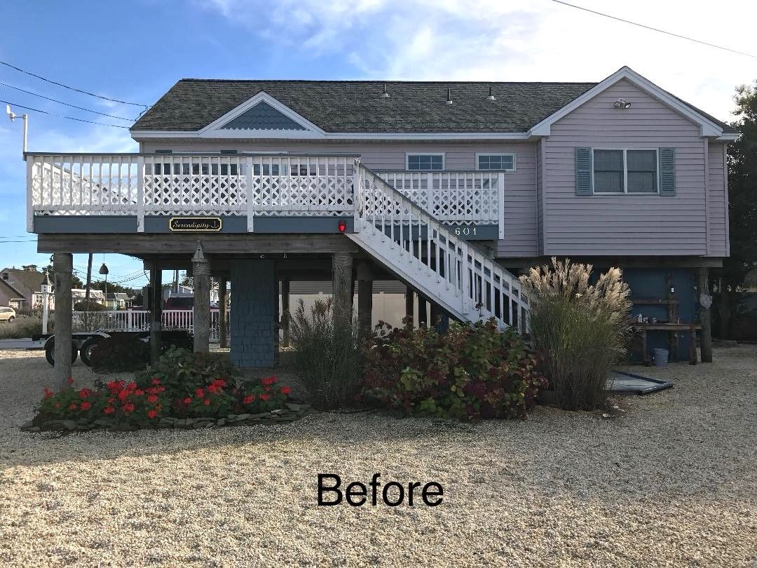 a before picture of a house with a large deck
