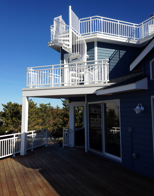 a blue house with a spiral staircase on top of it