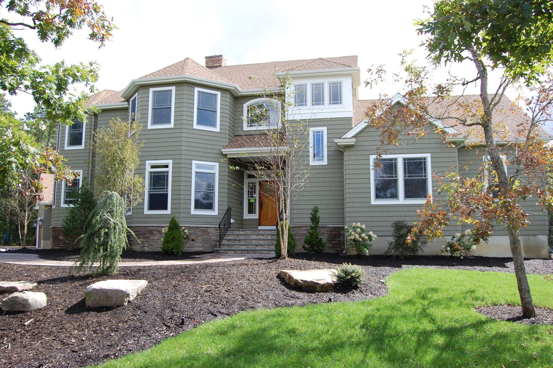 a large house with a lot of windows and trees in front of it