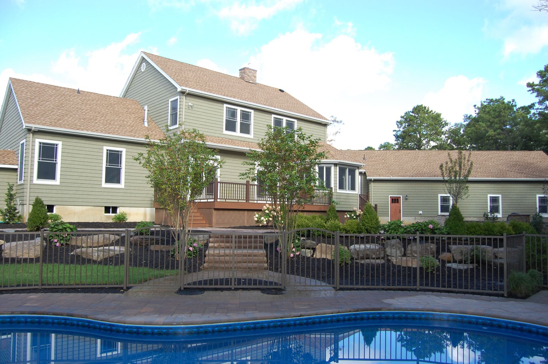 a large house with a pool in front of it