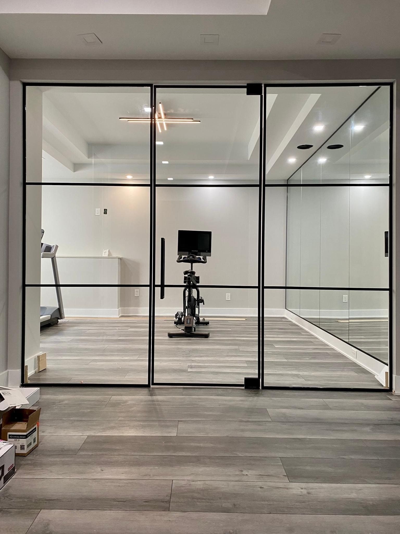 Workout room with interior glass walls and door