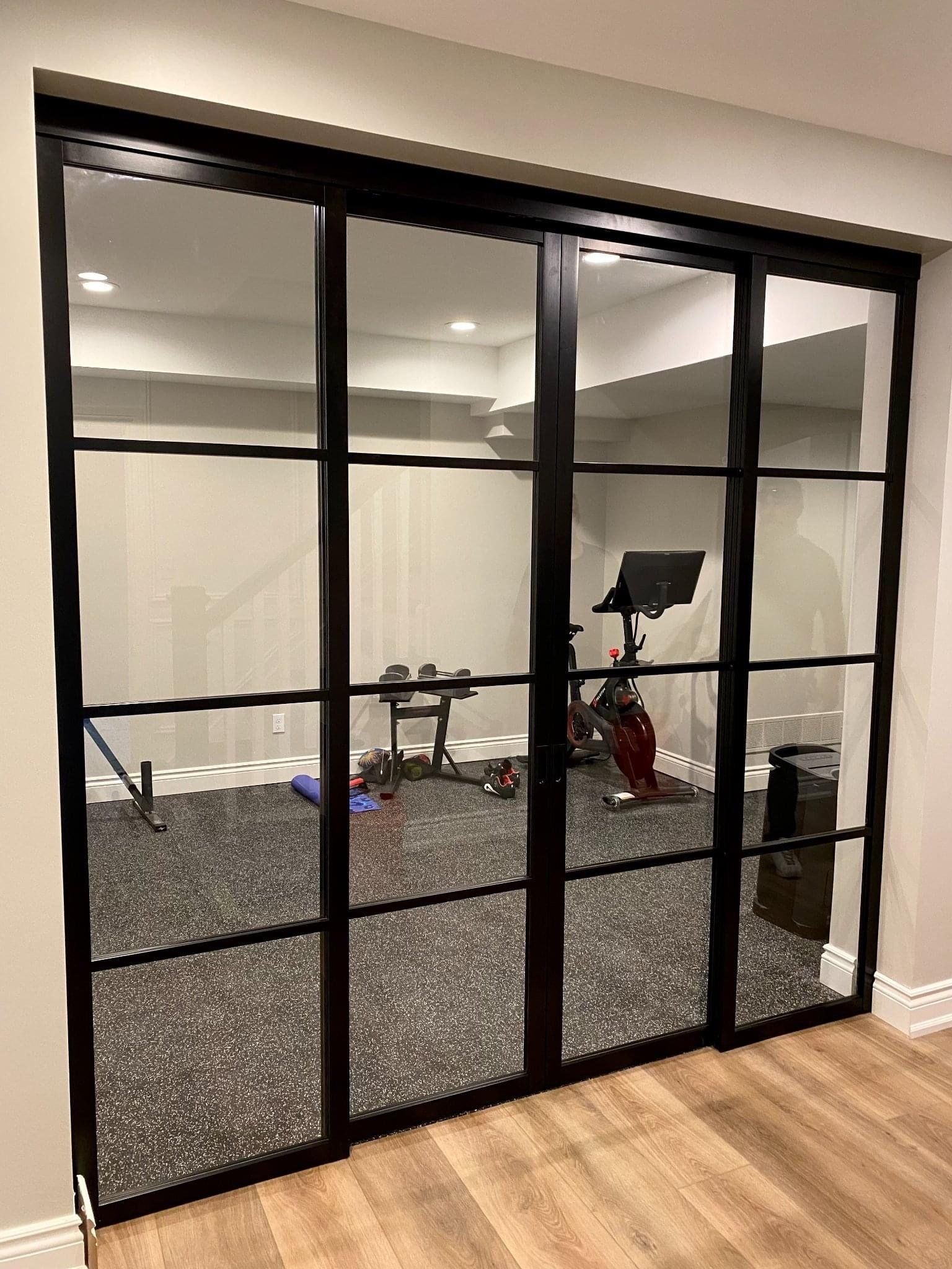 Workout room with interior glass walls and door