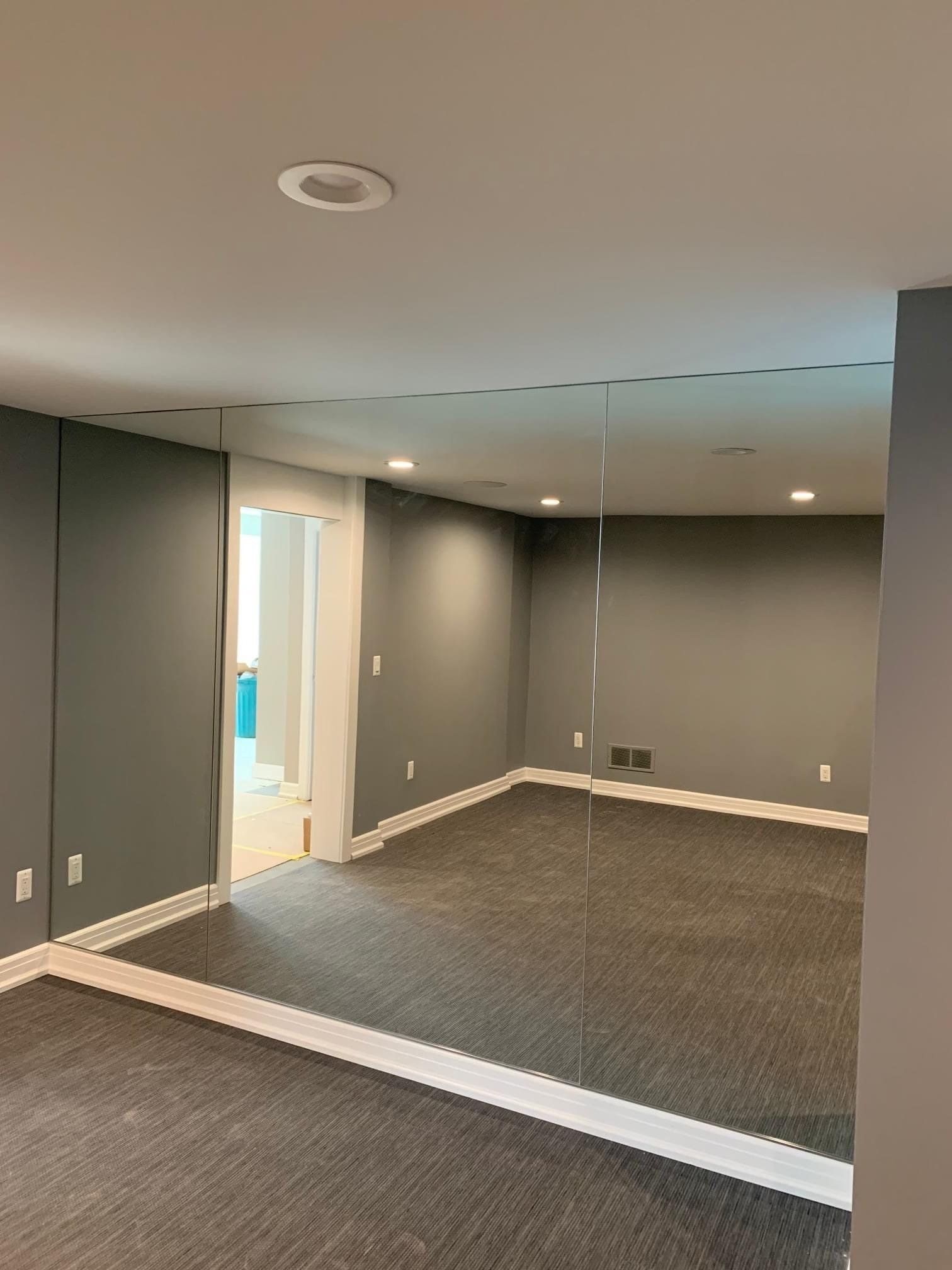 Empty room with a mirror wall