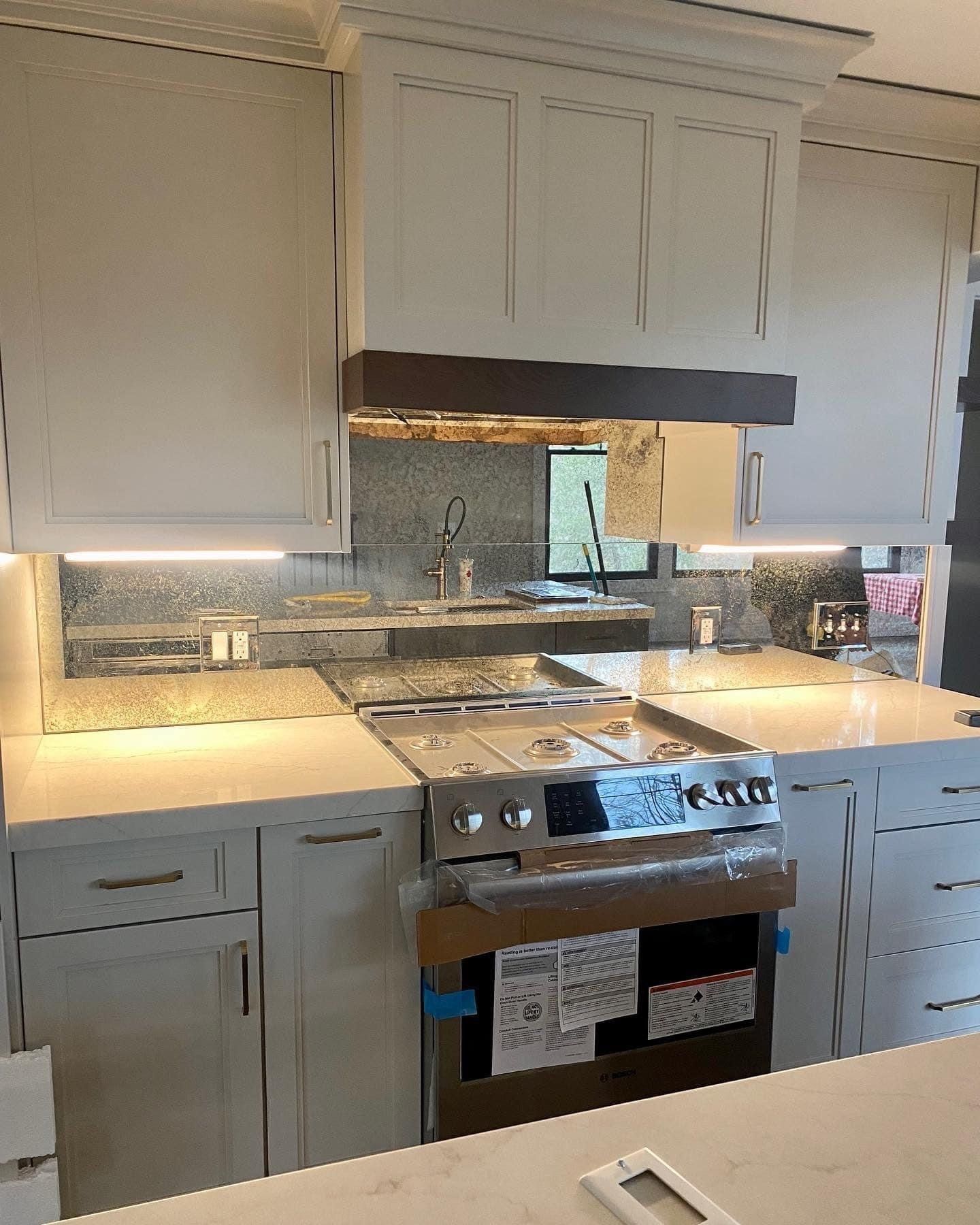 Kitchen with mirror splashback