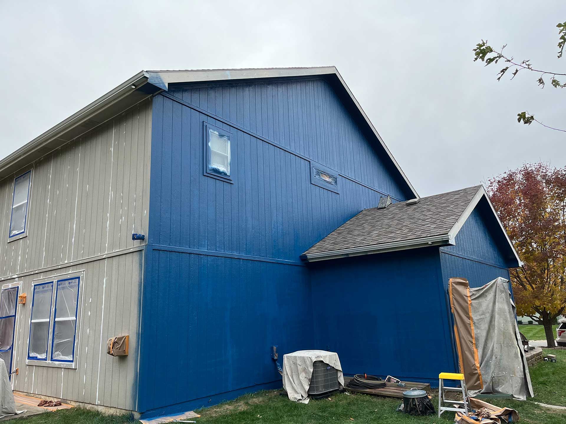 two-story house with blue painted siding