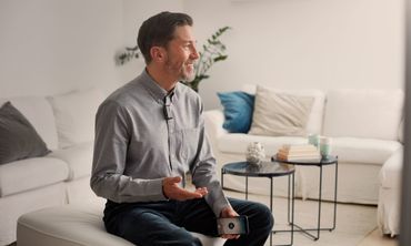 A man sitting with a hearing aid