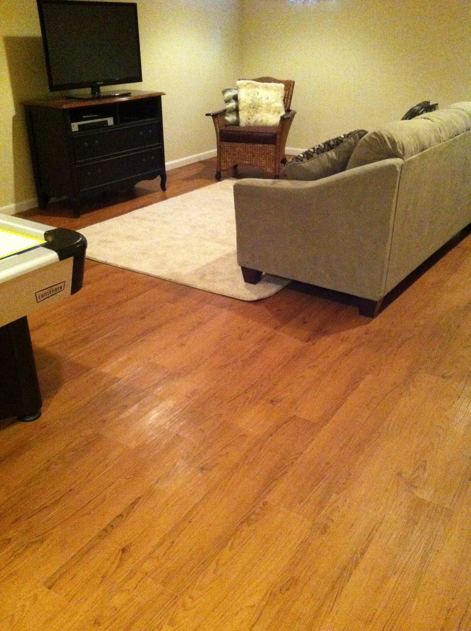 A living room with a couch , chair , table and television.