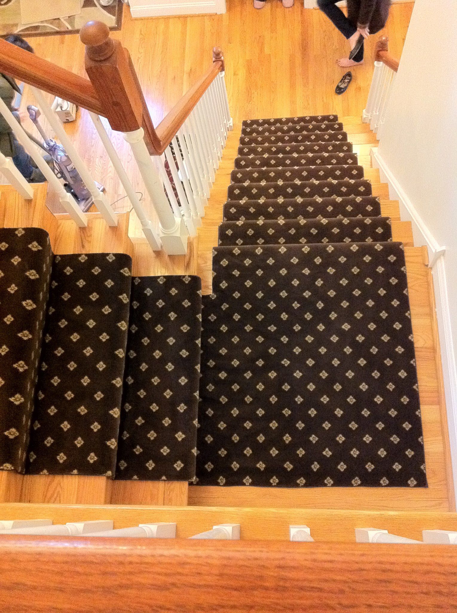 A staircase with a black carpet on the steps