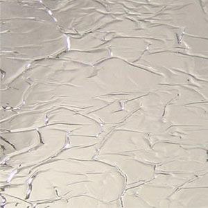 Cracked beige plaster wall with irregular textured lines