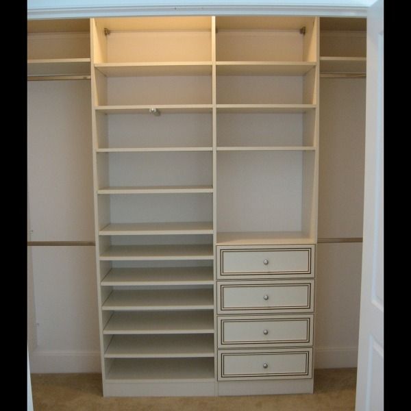 Built-in white closet with open shelves and drawers, empty and ready for storage.